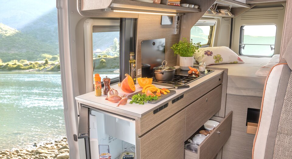Spacious Kitchen | Double-hinged refrigerator for easy access from inside and outside the vehicle